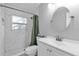 Contemporary bathroom featuring a vanity, shower with a green curtain, and modern fixtures, perfect for everyday use at 728 Vicksburg St, Deltona, FL 32725