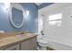 Bright bathroom featuring a tub with white tile surround and light blue walls at 728 Vicksburg St, Deltona, FL 32725