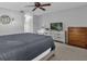 Bedroom featuring a bed, a ceiling fan, a dresser, and a TV on top of a second dresser at 728 Vicksburg St, Deltona, FL 32725