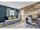 Charming bedroom with wood accent wall, desk, and ample natural light at 728 Vicksburg St, Deltona, FL 32725