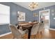 Formal dining room with stylish chandelier and seating for six guests at 728 Vicksburg St, Deltona, FL 32725