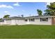 Charming white brick home with a well-manicured lawn and an attached two-car garage at 728 Vicksburg St, Deltona, FL 32725