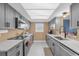 Modern kitchen with stainless steel appliances, sleek gray cabinetry, and ample counter space at 728 Vicksburg St, Deltona, FL 32725