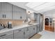 Well-lit kitchen with stainless steel appliances, gray cabinetry, and granite countertops at 728 Vicksburg St, Deltona, FL 32725