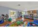Bright and airy living area with hardwood floors and a sliding glass door to the backyard at 728 Vicksburg St, Deltona, FL 32725