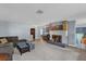 Spacious living room featuring a stone fireplace and ample natural light at 728 Vicksburg St, Deltona, FL 32725