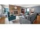 Cozy living room with a striking stone fireplace, elegant furniture, and ample natural light at 728 Vicksburg St, Deltona, FL 32725