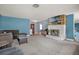 Spacious living room featuring a stone fireplace, and neutral carpeting at 728 Vicksburg St, Deltona, FL 32725