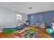 Playroom featuring a colorful play mat, toys, and a window into the kitchen at 728 Vicksburg St, Deltona, FL 32725