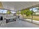 Enclosed sunroom with a daybed and outdoor view, ideal for relaxing and enjoying the outdoor scenery at 728 Vicksburg St, Deltona, FL 32725