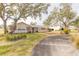 House exterior with a curved driveway and landscaping at 772 N Beach St, Ormond Beach, FL 32174