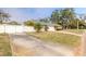 House exterior with a white fence and gated driveway at 772 N Beach St, Ormond Beach, FL 32174