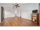 Bright bedroom with wood-look floors, ceiling fan, and en-suite bathroom at 794 Selby St, Deltona, FL 32725