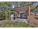 Outdoor kitchen area with pizza oven and smoker under a pergola at 811 W Minnesota Ave, Deland, FL 32720