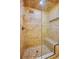 Tiled walk-in shower features a glass enclosure, bench, and recessed niche in this luxurious bathroom at 949 Tall Pine Dr, Port Orange, FL 32127