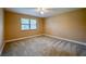 Bedroom with neutral walls, carpet floors, large window, ceiling fan, and natural light at 949 Tall Pine Dr, Port Orange, FL 32127