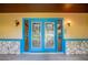 Elegant glass paneled double front doors with stone accents and modern lighting fixtures creating a welcoming entrance at 949 Tall Pine Dr, Port Orange, FL 32127