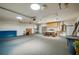 Large garage featuring ample storage, shelving, and a utility sink for various projects at 949 Tall Pine Dr, Port Orange, FL 32127