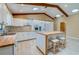 Well-lit kitchen with white cabinets, wood countertops, kitchen island with seating, and a seamless connection to the living area at 949 Tall Pine Dr, Port Orange, FL 32127