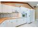 Bright kitchen features white cabinets, wooden countertops, stylish backsplash and stainless steel appliances at 949 Tall Pine Dr, Port Orange, FL 32127