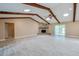 Spacious living room with vaulted ceilings, wood beams, fireplace, and an open design, seamlessly connecting to other living spaces at 949 Tall Pine Dr, Port Orange, FL 32127