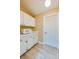 This pantry features wood-look tile flooring, built-in cabinets, and a white door at 949 Tall Pine Dr, Port Orange, FL 32127