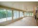 Large sunroom filled with windows and tile flooring at 949 Tall Pine Dr, Port Orange, FL 32127