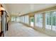 Bright sunroom featuring tile flooring and many windows at 949 Tall Pine Dr, Port Orange, FL 32127