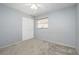 Simple bedroom with neutral walls, carpet, and a double door closet at 1016 Martex Dr, Apopka, FL 32703