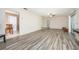 Living room with light gray laminate flooring and access to other rooms at 1016 Martex Dr, Apopka, FL 32703