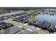 Aerial view of a residential street with lake, landscaping, and well-maintained homes at 105 Cerise Ct, Daytona Beach, FL 32124