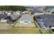 Aerial view of a well-maintained home showcasing a fenced yard, screened pool, and solar panels at 105 Cerise Ct, Daytona Beach, FL 32124