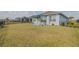 Expansive backyard featuring lush green lawn, black fence, patio, and mature landscaping at 105 Cerise Ct, Daytona Beach, FL 32124