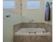 Bathroom featuring a soaking tub with tile surround and modern fixtures at 105 Cerise Ct, Daytona Beach, FL 32124