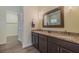 Double vanity bathroom with granite countertops, modern fixtures, and a walk-in closet at 105 Cerise Ct, Daytona Beach, FL 32124