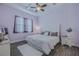 Bright bedroom with a tray ceiling, ceiling fan and a plush white bed at 105 Cerise Ct, Daytona Beach, FL 32124