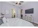 Light-filled bedroom featuring a tray ceiling, ensuite bathroom and a decorative dresser at 105 Cerise Ct, Daytona Beach, FL 32124