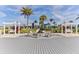 A fire pit area with seating, surrounded by lush landscaping, and a pergola covered swingset at 105 Cerise Ct, Daytona Beach, FL 32124
