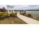 Community fishing pier with seating and beautiful landscaping overlooking the lake at 105 Cerise Ct, Daytona Beach, FL 32124