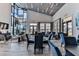An open community lounge area with tables, chairs, and floor-to-ceiling windows offering views of the outdoors at 105 Cerise Ct, Daytona Beach, FL 32124