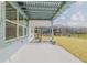 Covered patio area with a view of the backyard, pool, and lake at 105 Cerise Ct, Daytona Beach, FL 32124