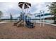 Community playground with slides, climbing bars, and other play equipment with a view of the lake at 105 Cerise Ct, Daytona Beach, FL 32124
