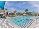 A large community pool with clear blue water, surrounded by a deck, lounge chairs, and a pool house at 105 Cerise Ct, Daytona Beach, FL 32124