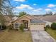 One-story house, two-car garage, and spacious yard at 10727 Brown Trout Cir, Orlando, FL 32825