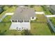 Aerial view of a home featuring a screened-in patio, brick fire pit, and fenced-in yard at 108 Blanco Dr, Deland, FL 32724