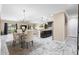 Open concept dining room flowing into the kitchen and living room with marble floors at 108 Blanco Dr, Deland, FL 32724