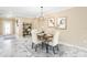 Dining room area featuring marble floors, modern chandelier, and stylish decor at 108 Blanco Dr, Deland, FL 32724