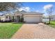 Exterior view of a charming one-story home with a two-car garage at 108 Blanco Dr, Deland, FL 32724