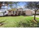 Charming single-story home with manicured lawn, stone accents, and a two-car garage at 108 Blanco Dr, Deland, FL 32724