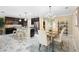 Beautiful kitchen with an island, dark cabinets, stainless steel appliances and gorgeous marble floors at 108 Blanco Dr, Deland, FL 32724